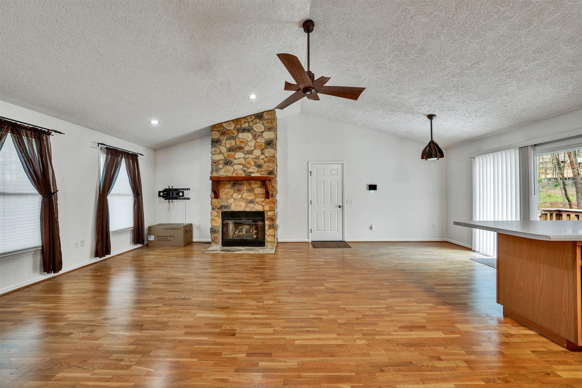 445 Middle Ridge Drive Callaway, VA 24067 - Photo 3 of 25 a view of an empty room with window and wooden floor