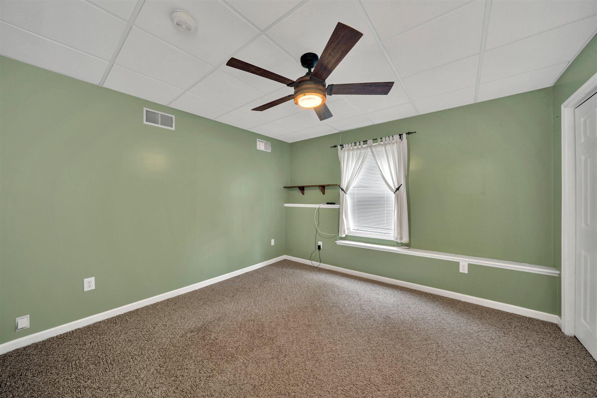 445 Middle Ridge Drive Callaway, VA 24067 - Photo 21 of 25 an empty room with ceiling fan and window