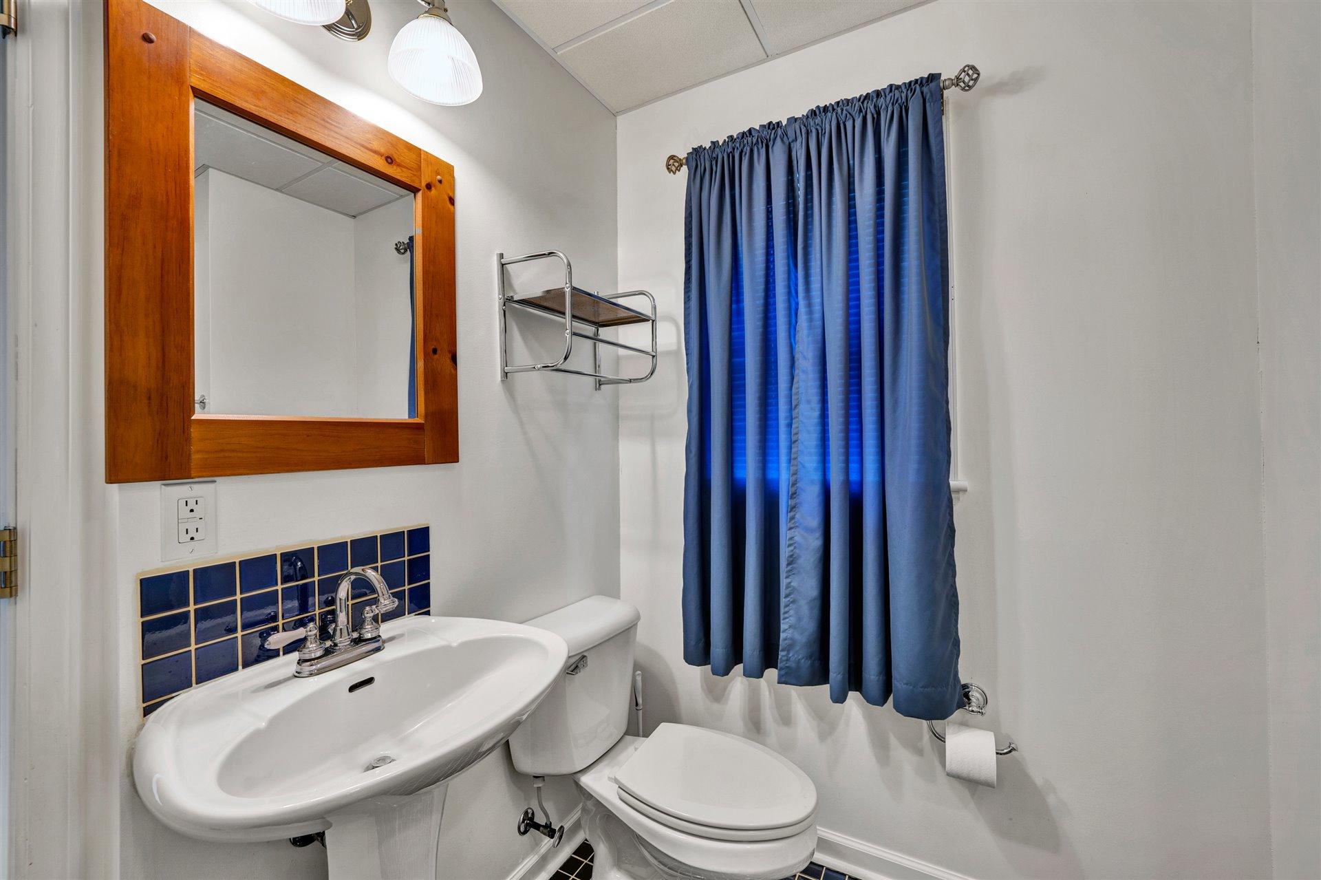 445 Middle Ridge Drive Callaway, VA 24067 - Photo 23 of 25 a bathroom with a toilet a sink and mirror