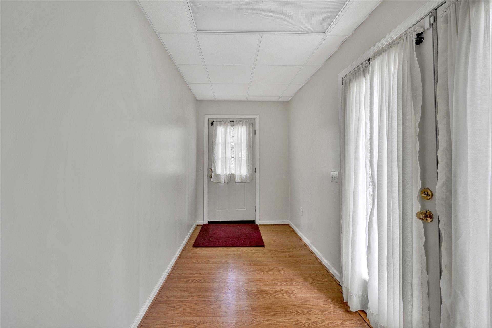 445 Middle Ridge Drive Callaway, VA 24067 - Photo 24 of 25 a view of a hallway with wooden floor and a bathroom