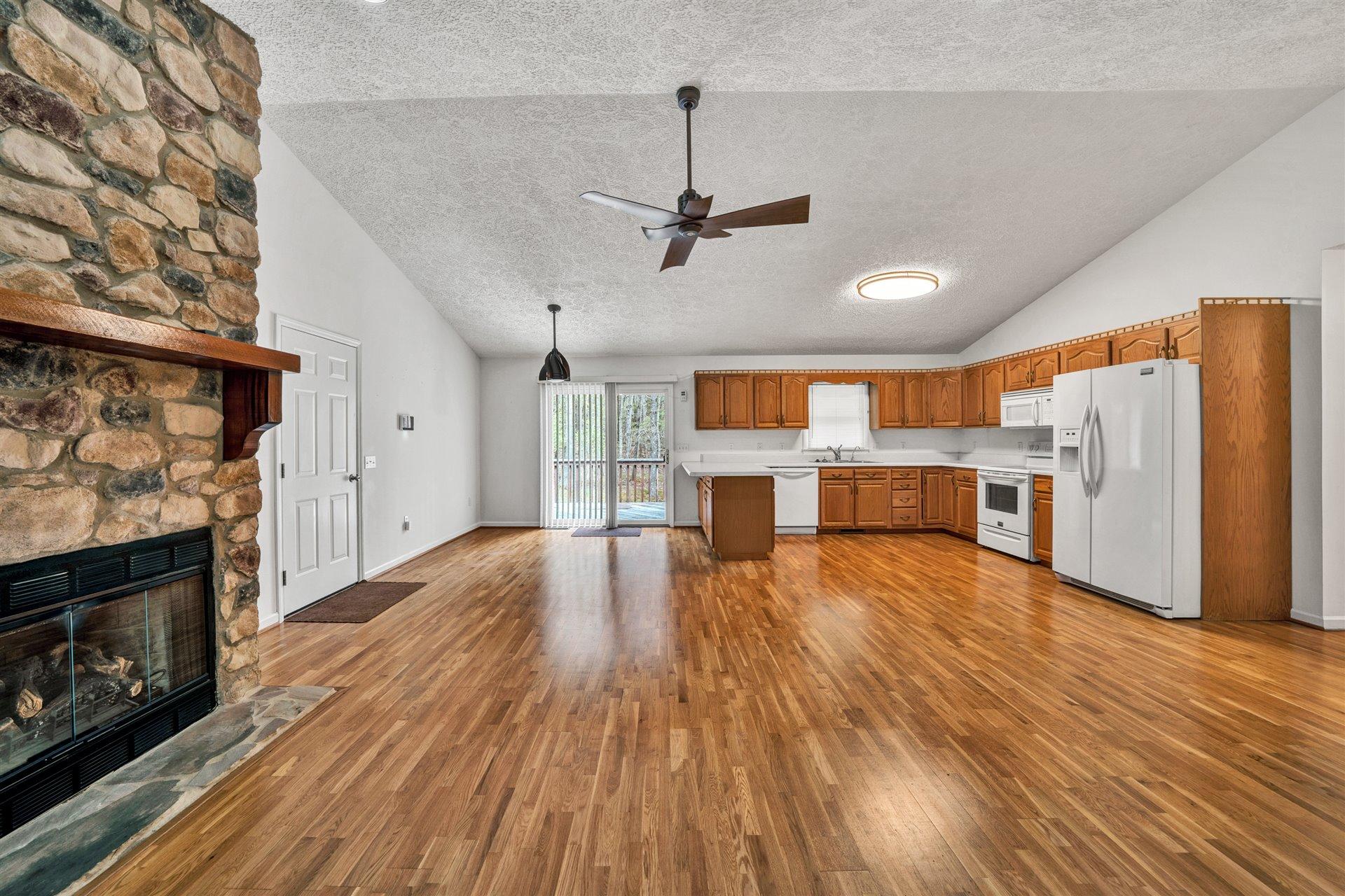445 Middle Ridge Drive Callaway, VA 24067 - Photo 5 of 25 a view of kitchen with refrigerator microwave and wooden floor