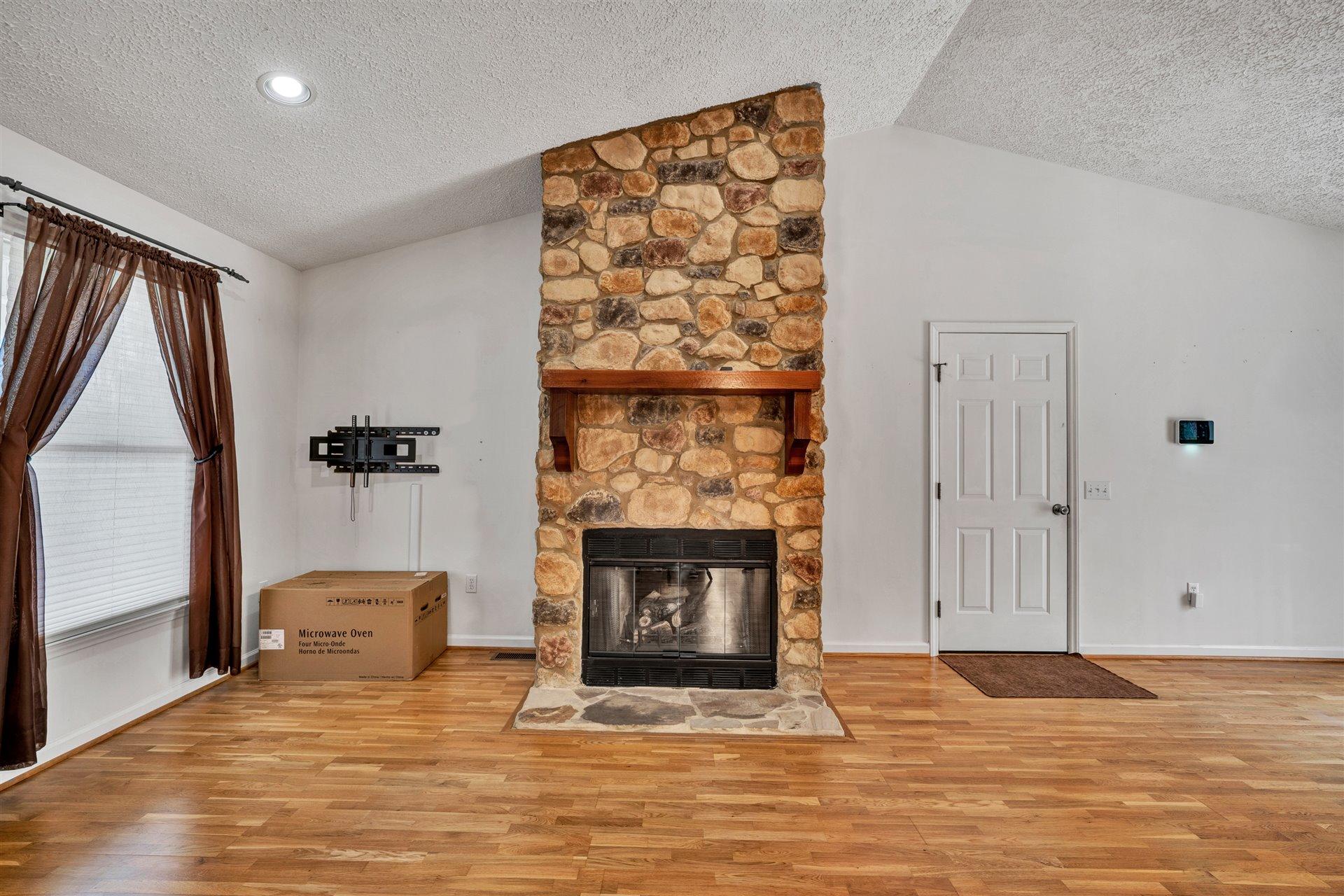 445 Middle Ridge Drive Callaway, VA 24067 - Photo 6 of 25 a view of a livingroom with an empty space and a fireplace