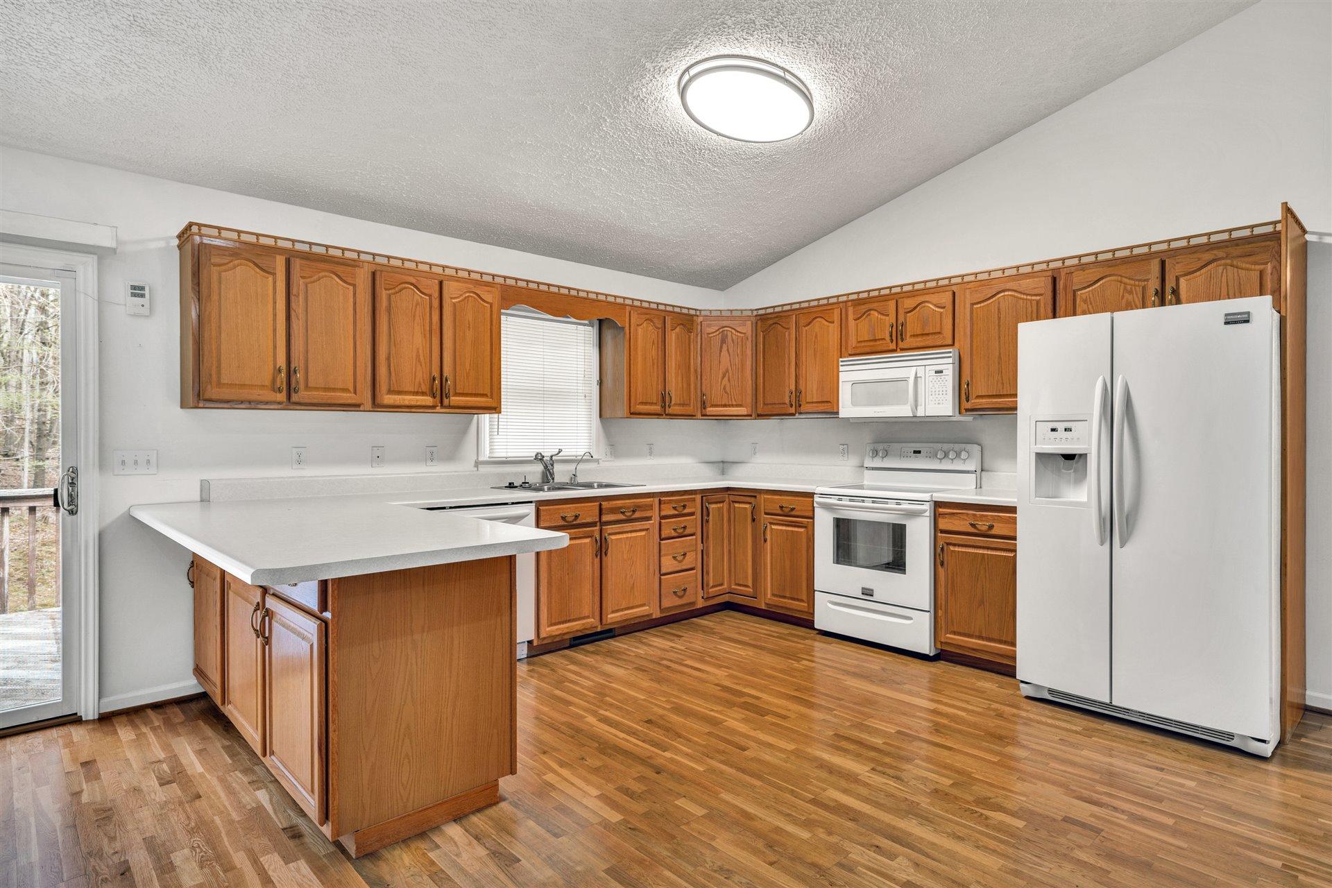 445 Middle Ridge Drive Callaway, VA 24067 - Photo 8 of 25 a kitchen with a refrigerator stove top oven and sink