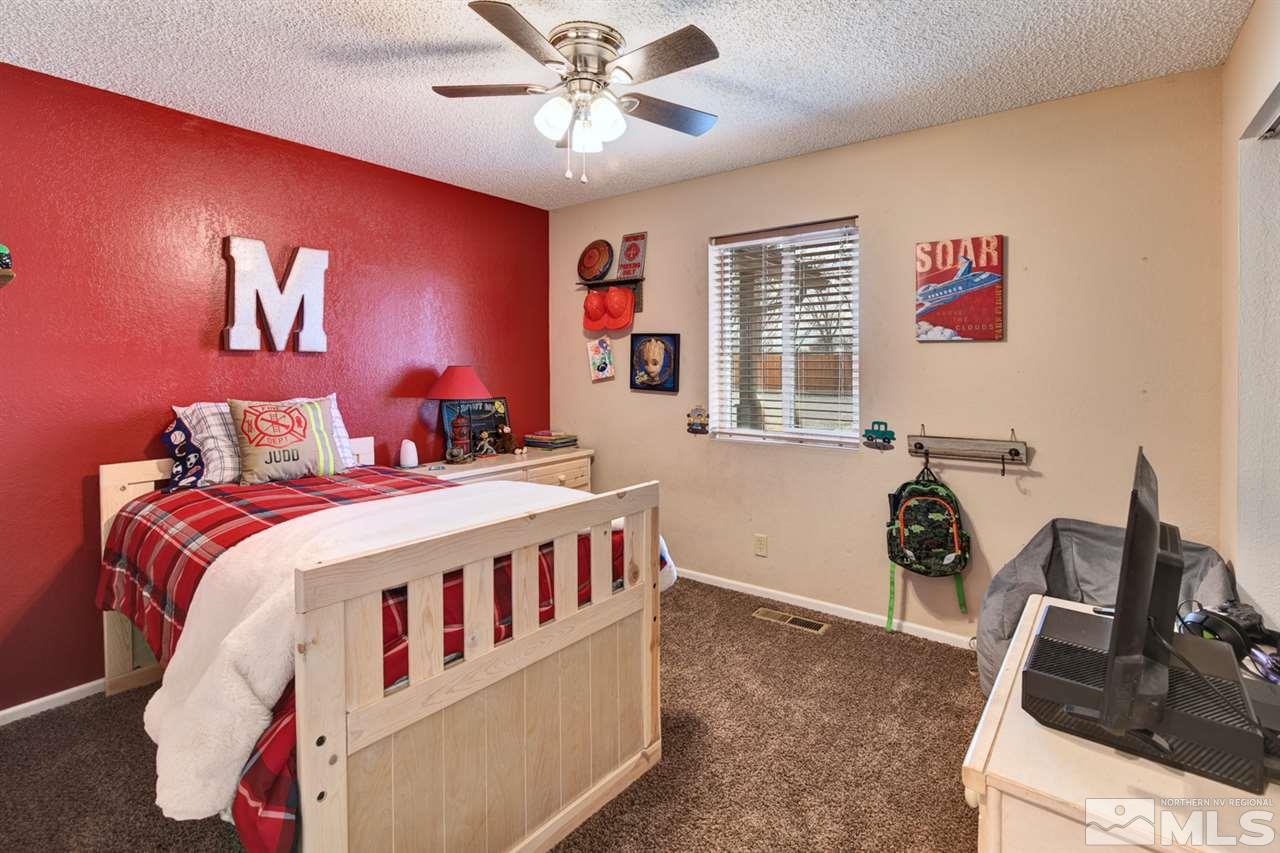 995 McLean Road Fallon, NV 89406 - Photo 11 of 25 a bedroom with a bed and a flat tv screen on the dresser