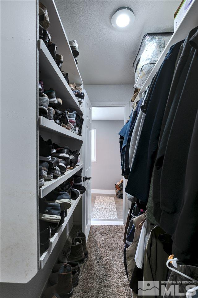 995 McLean Road Fallon, NV 89406 - Photo 17 of 25 a view of walk in closet with clothes and shoes