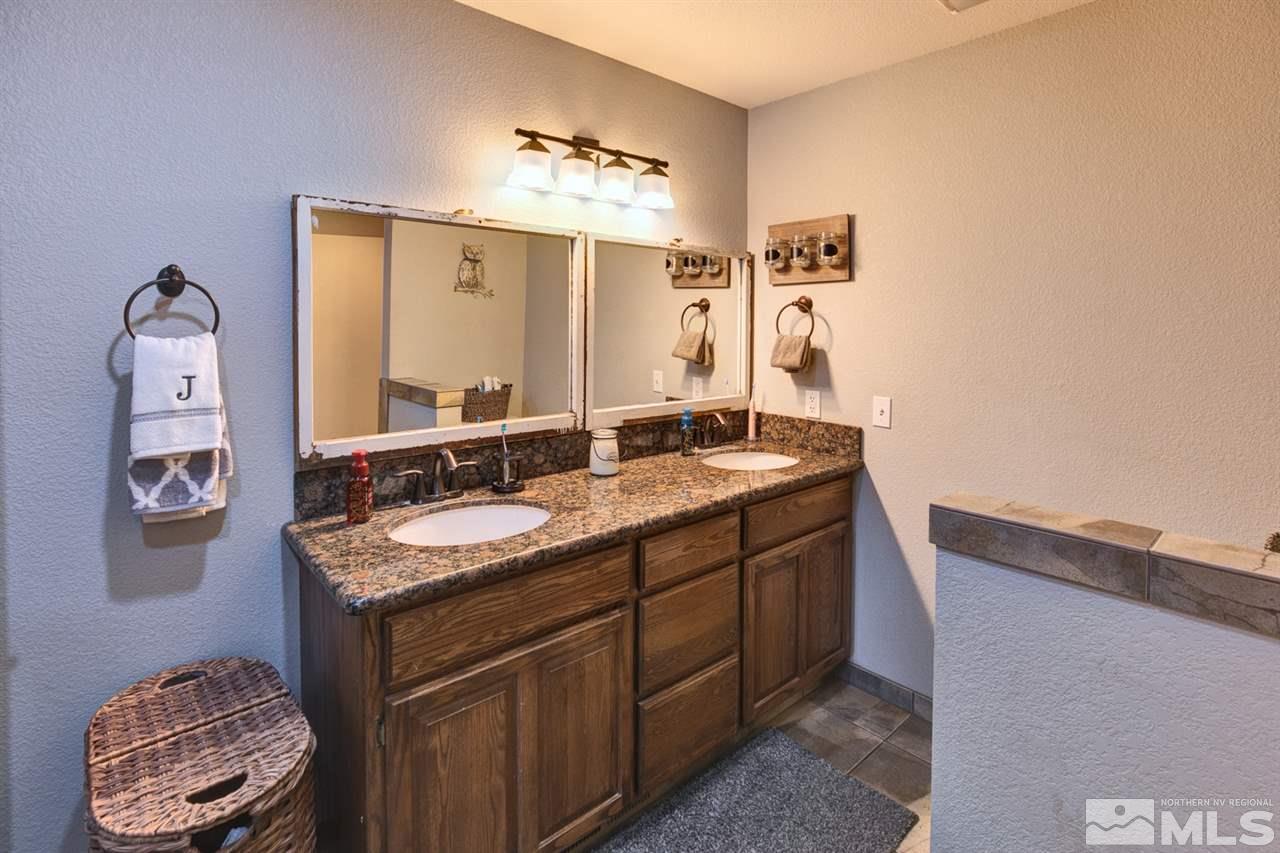 995 McLean Road Fallon, NV 89406 - Photo 19 of 25 a bathroom with a granite countertop sink and a mirror