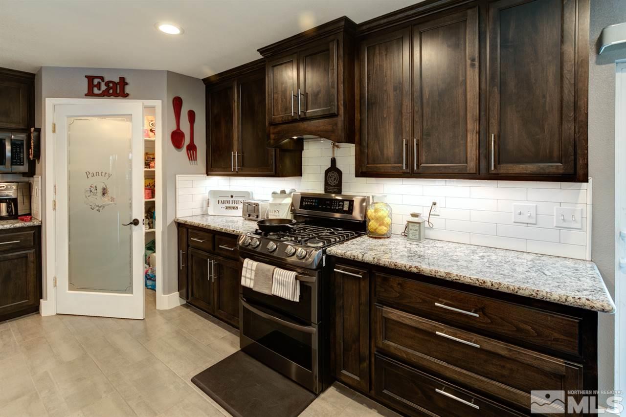 995 McLean Road Fallon, NV 89406 - Photo 6 of 25 a kitchen with granite countertop wooden cabinets and stainless steel appliances