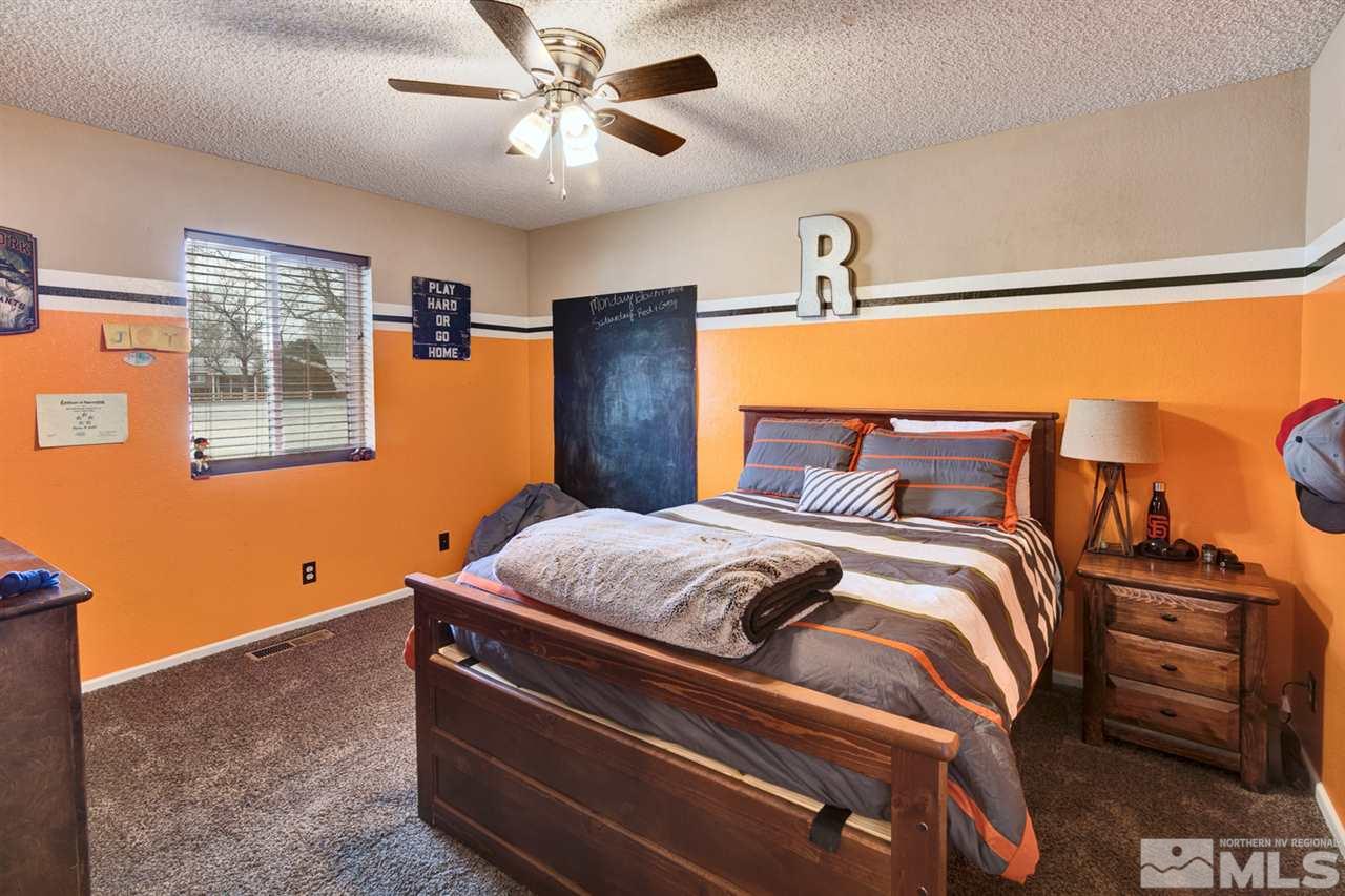995 McLean Road Fallon, NV 89406 - Photo 9 of 25 a bedroom with a bed and wooden floor