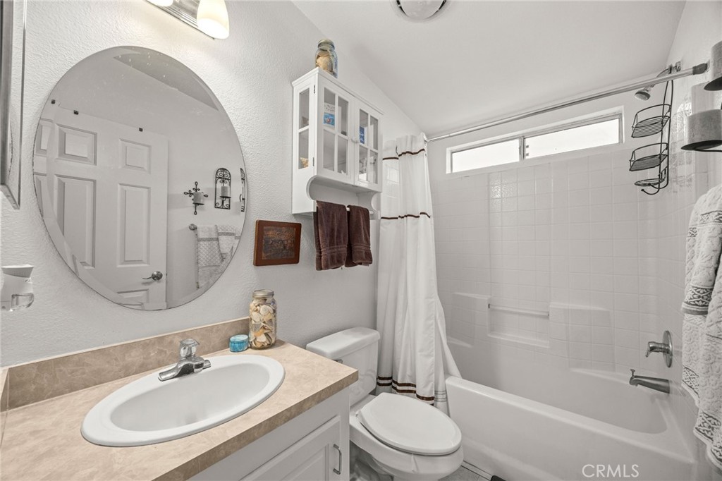 23301 Ridge Rte Drive, Unit 229 Laguna Hills, CA 92653 - Photo 16 of 28 a bathroom with a sink a toilet and shower