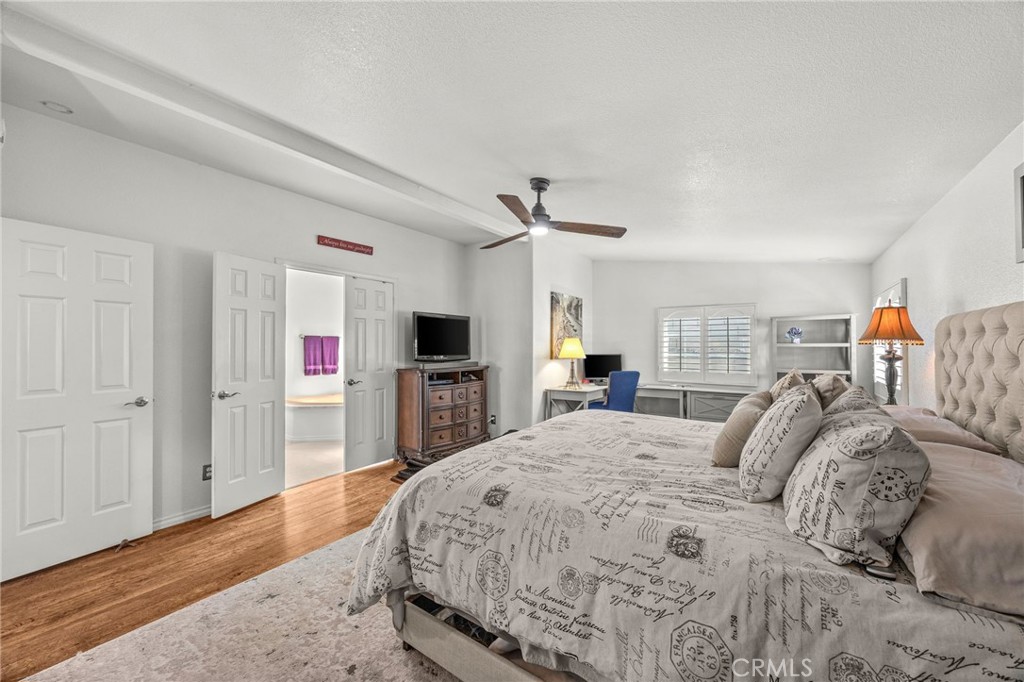 23301 Ridge Rte Drive, Unit 229 Laguna Hills, CA 92653 - Photo 19 of 28 a spacious bedroom with a bed and a flat screen tv