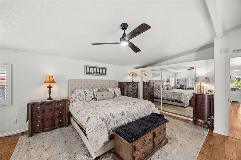 23301 Ridge Rte Drive, Unit 229 Laguna Hills, CA 92653 - Photo 20 of 28 a bedroom with a bed and ceiling fan
