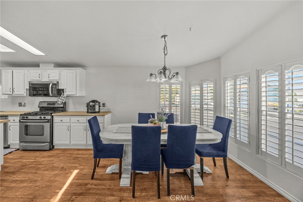 23301 Ridge Rte Drive, Unit 229 Laguna Hills, CA 92653 - Photo 5 of 28 a view of a dining room with furniture window and wooden floor