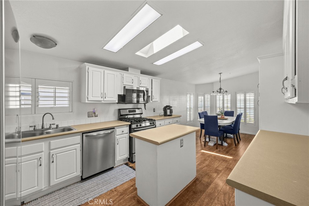 23301 Ridge Rte Drive, Unit 229 Laguna Hills, CA 92653 - Photo 8 of 28 a kitchen with appliances a sink and cabinets