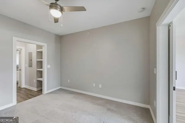 an empty room with a empty space and a ceiling fan