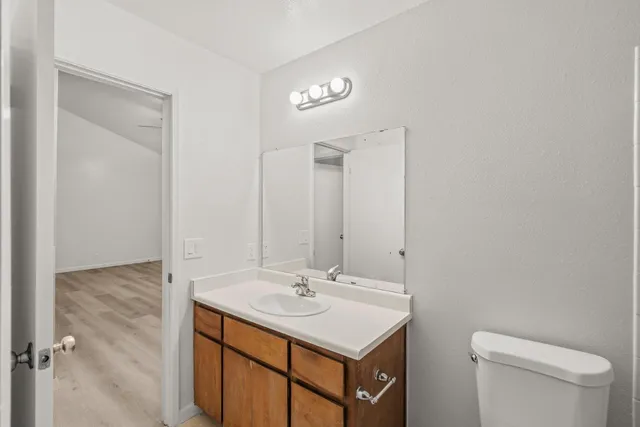 an empty room with wooden floor and window