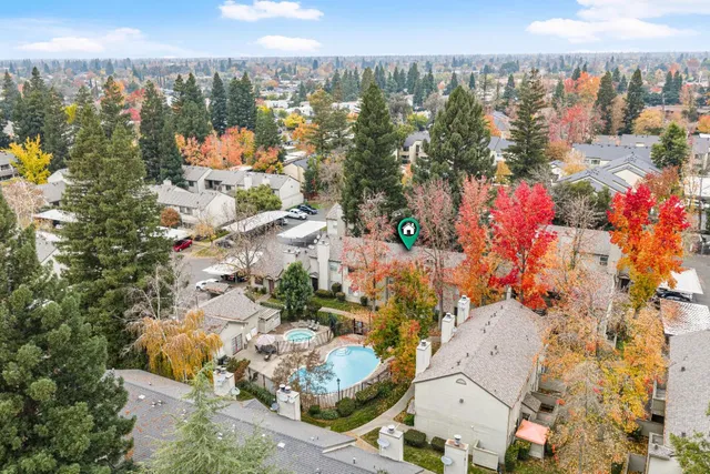 an aerial view of a house with swimming pool and outdoor seating