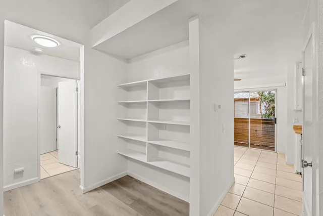 a view of walk in closet with empty racks