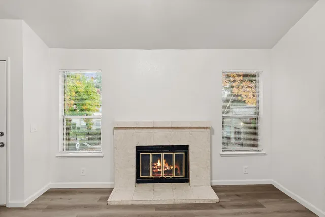 a living room with a fireplace and a window