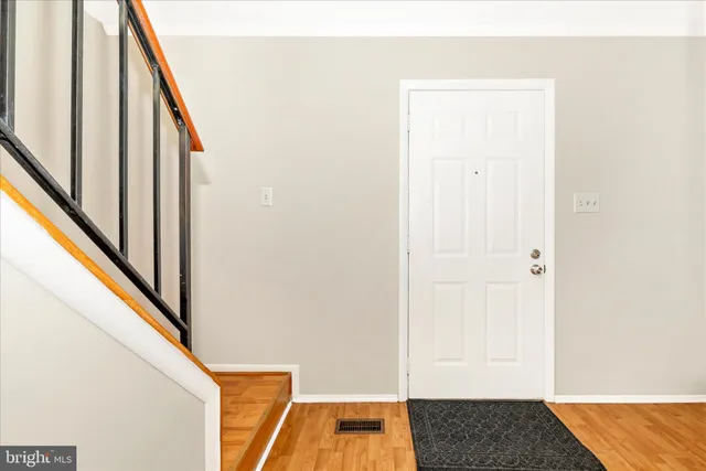 a front view of a house with a yard covered in snow