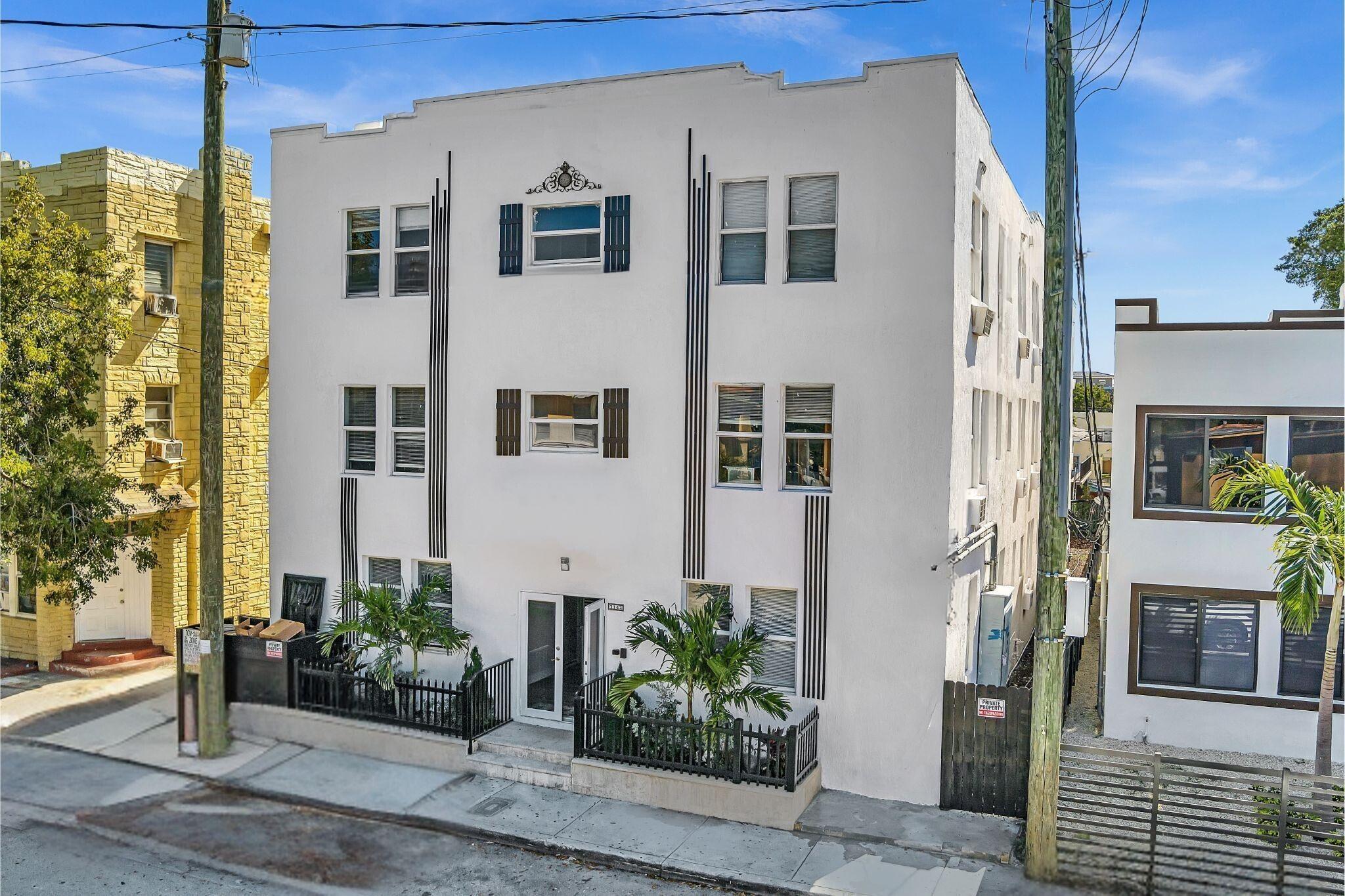 1142 Southwest 4th Street, Unit 9 Miami, FL 33130 - Photo 1 of 9 a front view of a building with potted plants