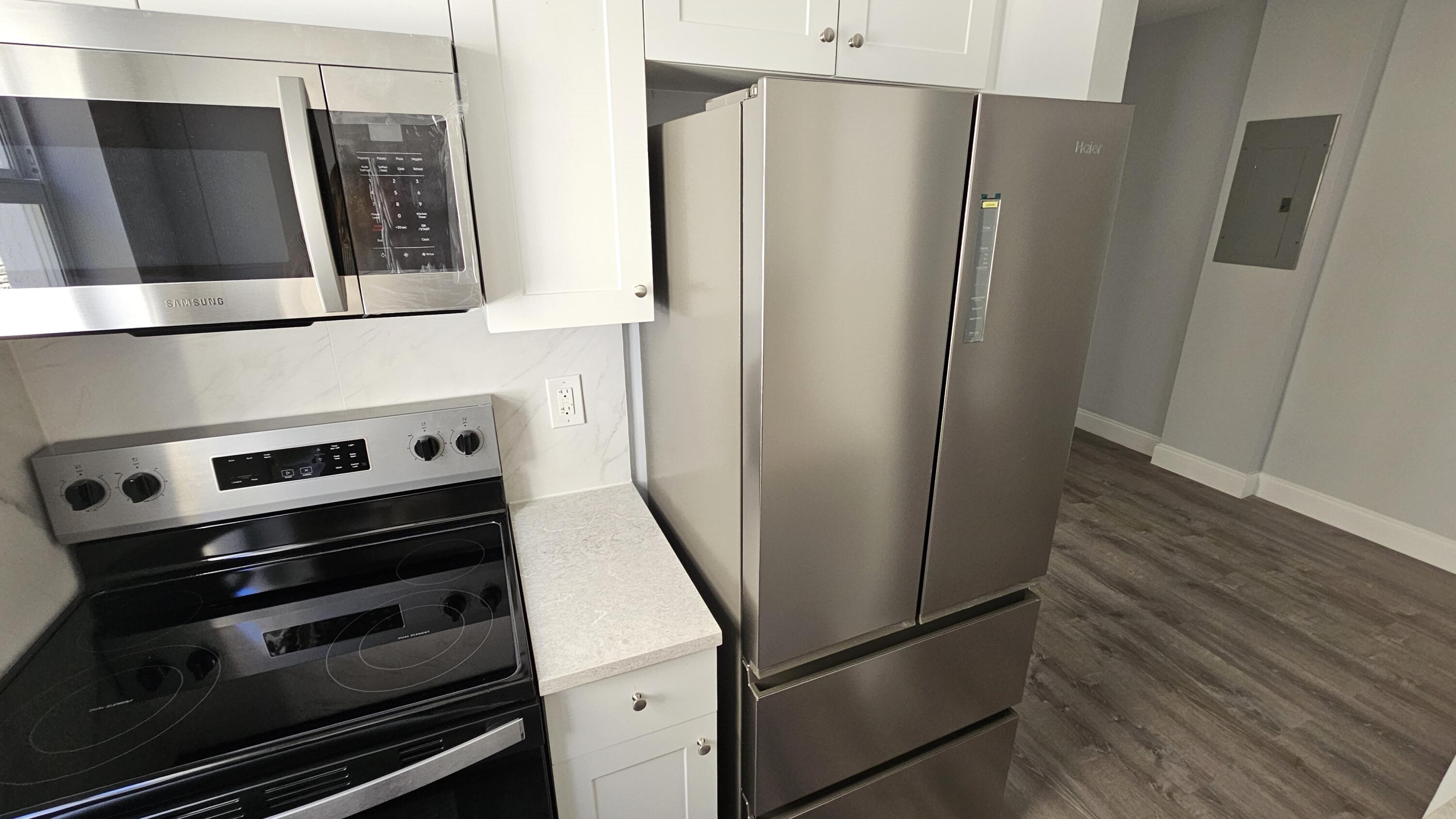 1142 Southwest 4th Street, Unit 9 Miami, FL 33130 - Photo 2 of 9 a metallic refrigerator freezer sitting in a kitchen