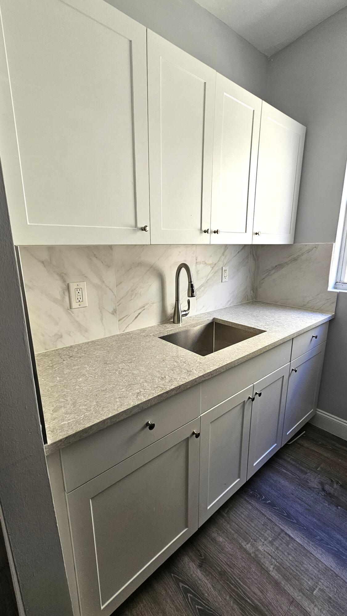 1142 Southwest 4th Street, Unit 9 Miami, FL 33130 - Photo 3 of 9 a kitchen with a sink and cabinets