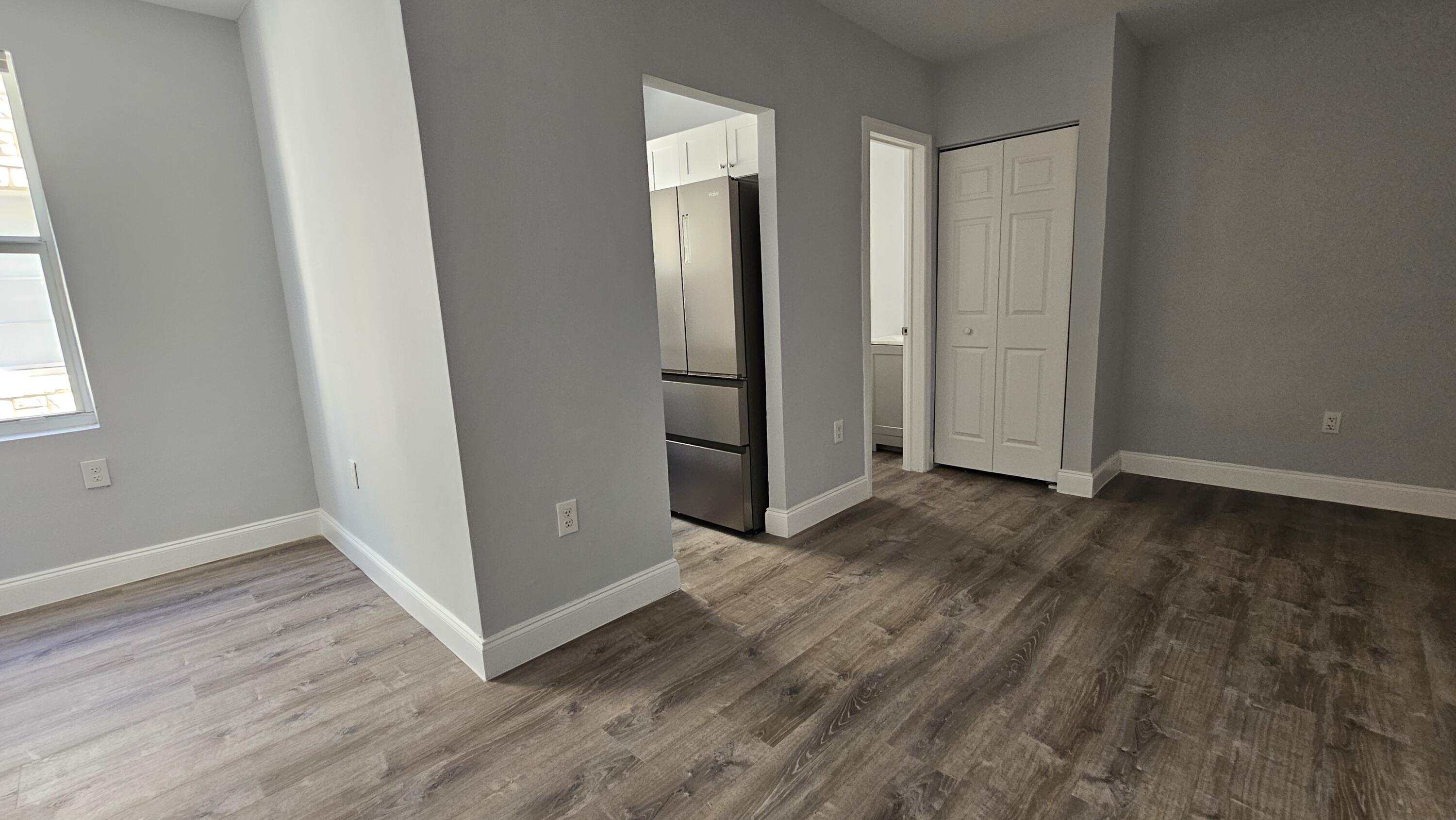 1142 Southwest 4th Street, Unit 9 Miami, FL 33130 - Photo 5 of 9 an empty room with wooden floor and closet