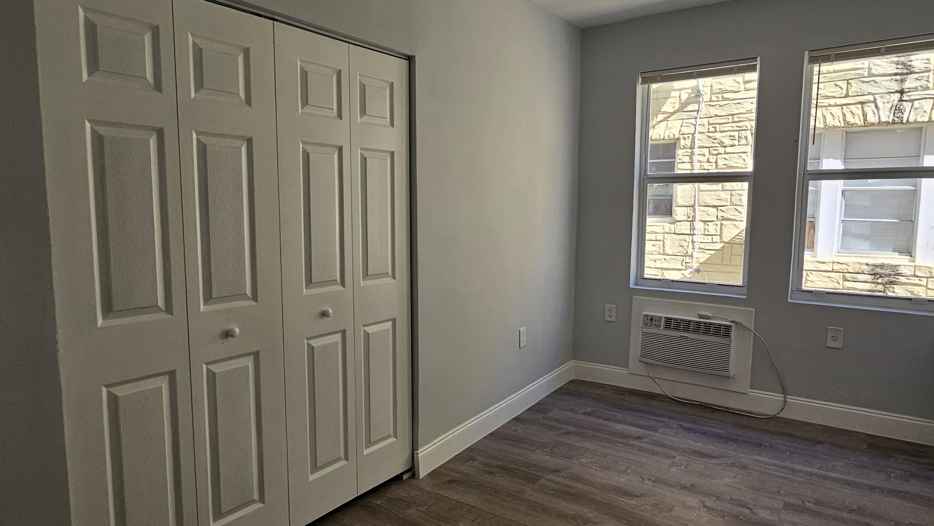 1142 Southwest 4th Street, Unit 9 Miami, FL 33130 - Photo 8 of 9 a view of an empty room with wooden floor and a window