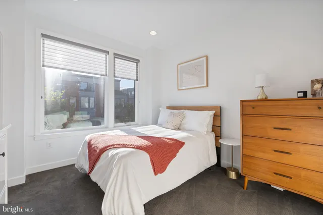 a bedroom with a large bed and a large window