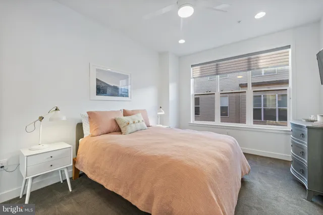 a spacious bedroom with a bed and a large window