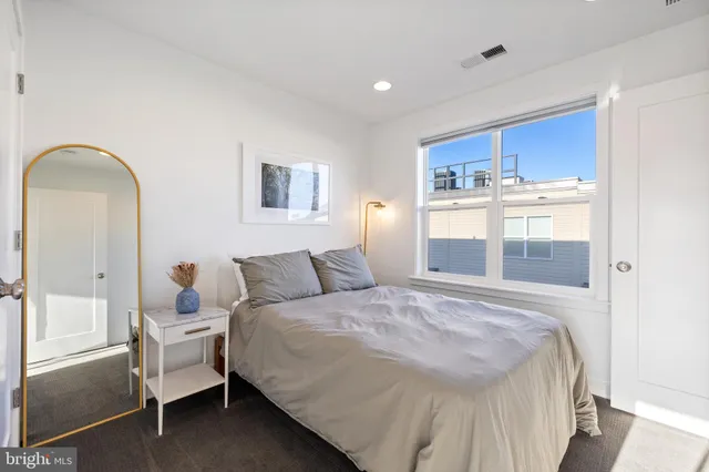 a bedroom with a large bed and a closet