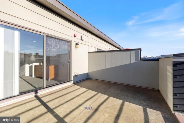 a view of a patio with couches and potted plants