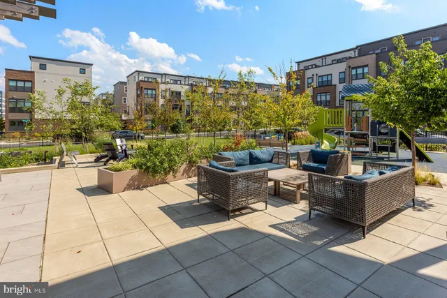a view of a patio with a table and chairs and potted plants