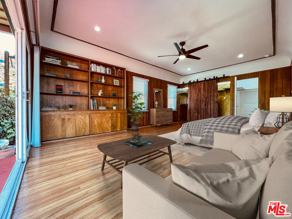 6187 Barrows Drive Los Angeles, CA 90048 - Photo 28 of 35 a bedroom with a large bed a chandelier and windows