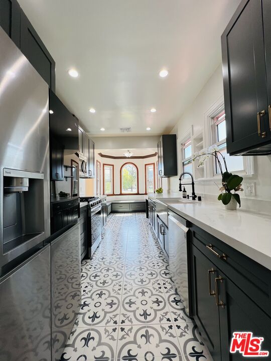 6187 Barrows Drive Los Angeles, CA 90048 - Photo 9 of 35 a large kitchen with a large counter top appliances and cabinets