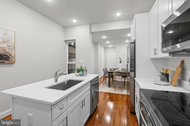 a kitchen with sink refrigerator and stove