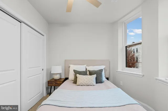 a bedroom with a bed and a window