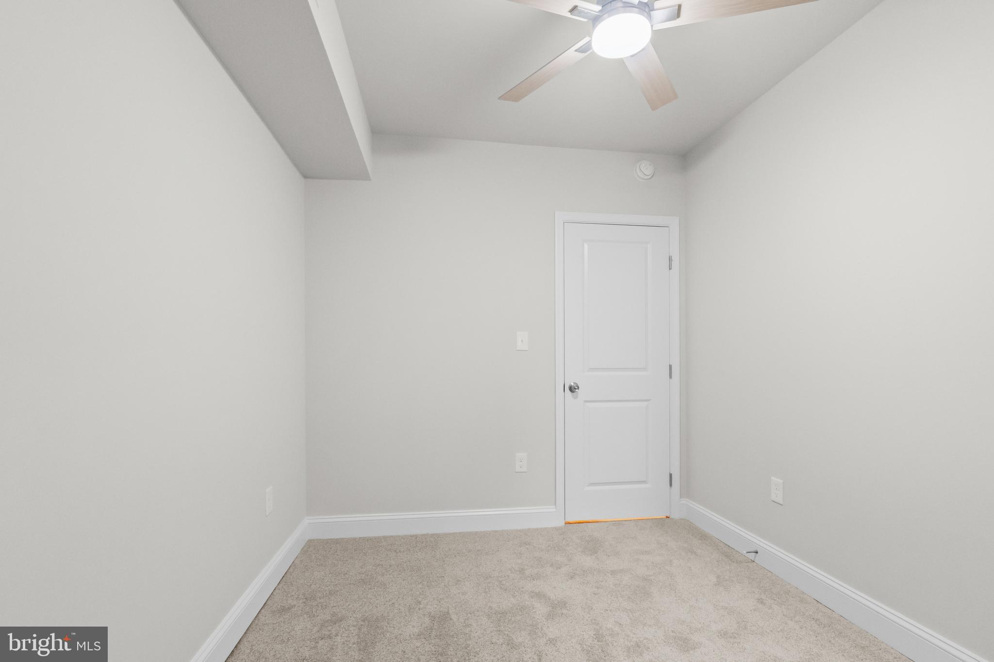 2103 McCulloh Street Baltimore, MD 21217 - Photo 24 of 56 an empty room with a ceiling fan and a window