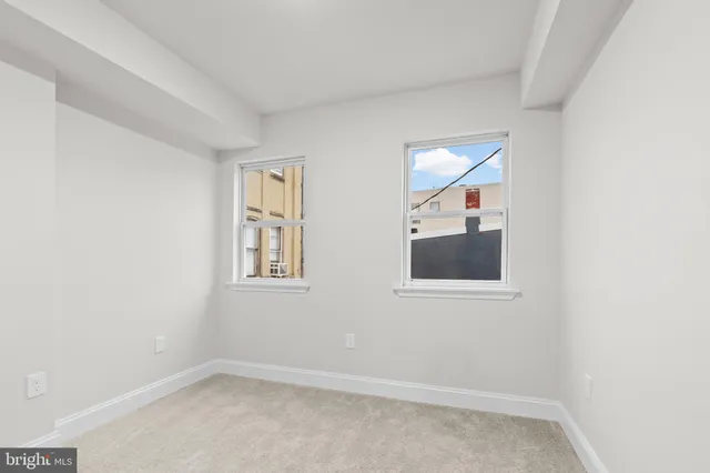 a view of small space with wooden floor and windows