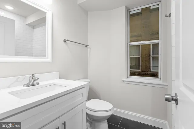 a white bath tub sitting next to a white sink and a shower