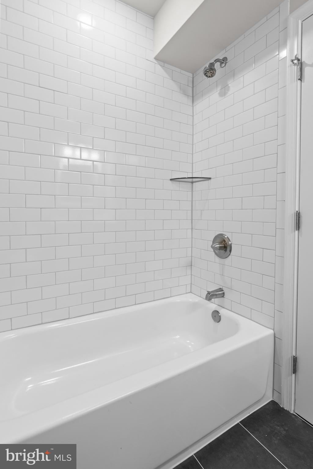 2103 McCulloh Street Baltimore, MD 21217 - Photo 29 of 56 a white bath tub sitting next to a white sink and a shower