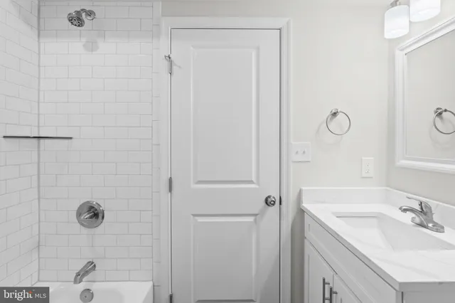a white tub sitting in a room next to a window
