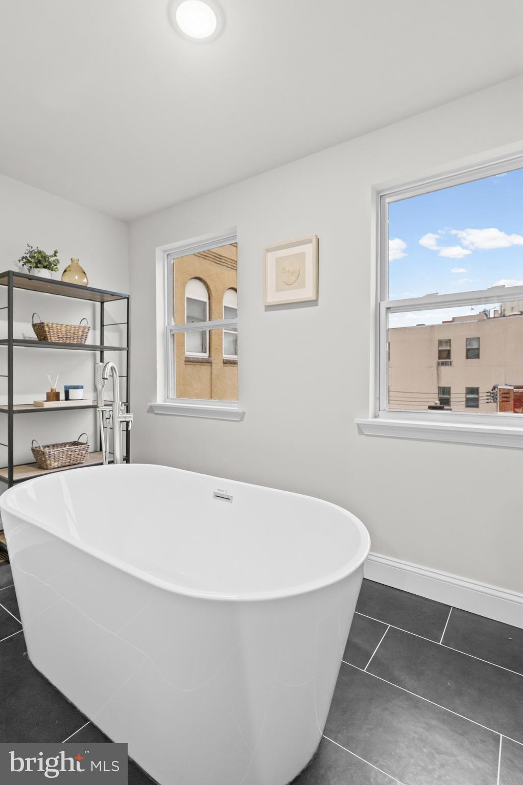 2103 McCulloh Street Baltimore, MD 21217 - Photo 32 of 56 a white tub sitting in a room next to a window
