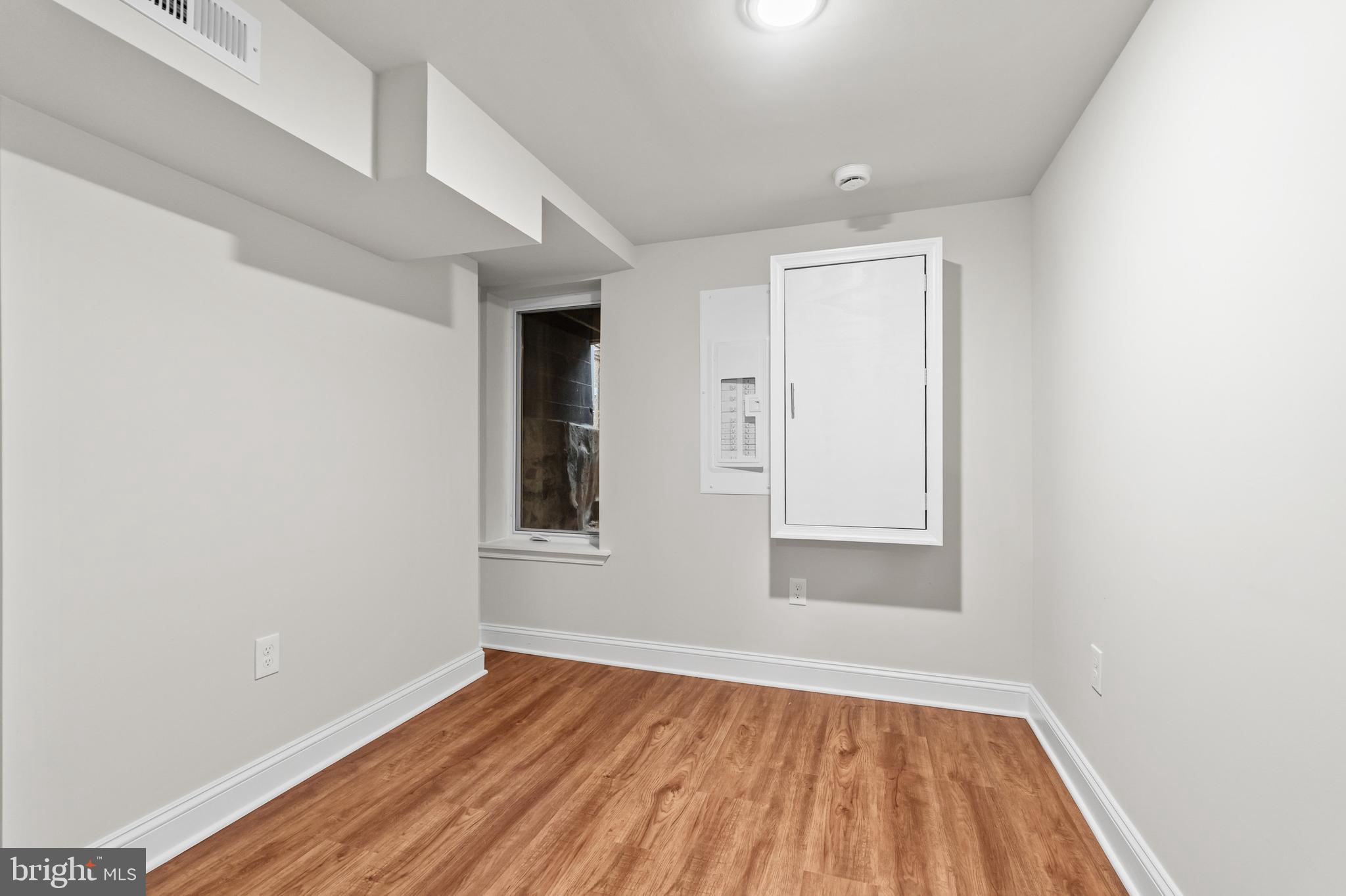 2103 McCulloh Street Baltimore, MD 21217 - Photo 39 of 56 a view of an empty room with wooden floor and a window