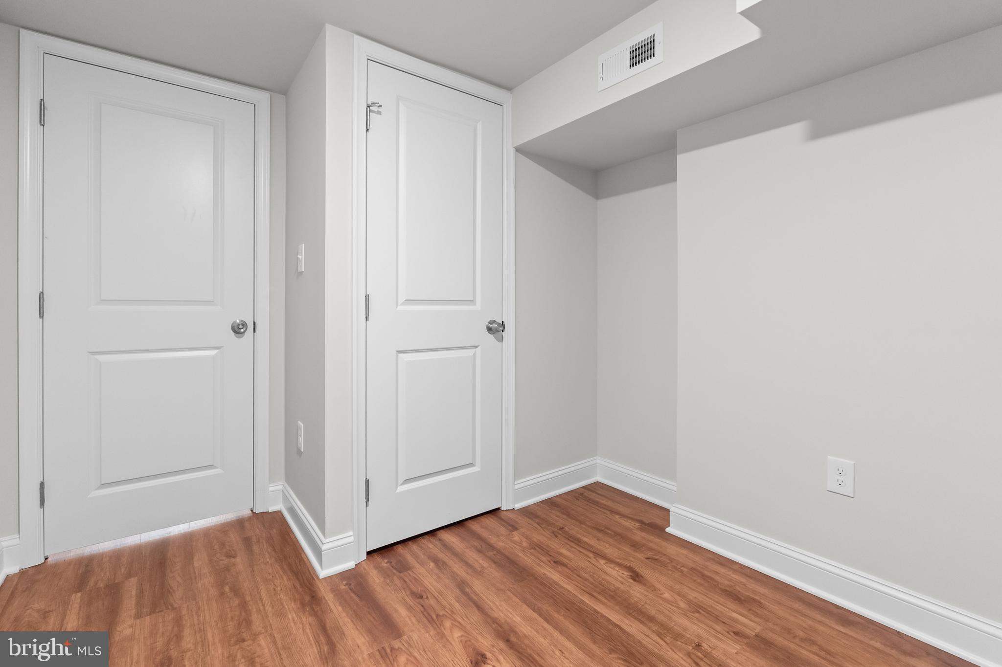 2103 McCulloh Street Baltimore, MD 21217 - Photo 40 of 56 a view of an empty room with wooden floor