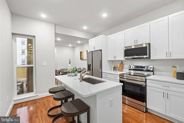 a kitchen with a sink cabinets and stainless steel appliances