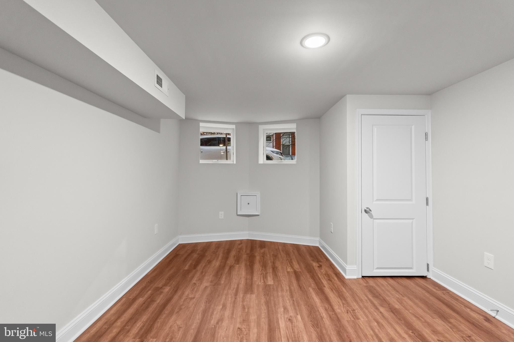 2103 McCulloh Street Baltimore, MD 21217 - Photo 44 of 56 an empty room with wooden floor and windows