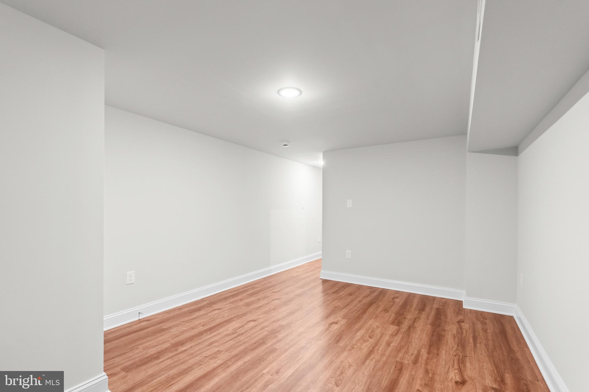 2103 McCulloh Street Baltimore, MD 21217 - Photo 45 of 56 a view of an empty room with wooden floor