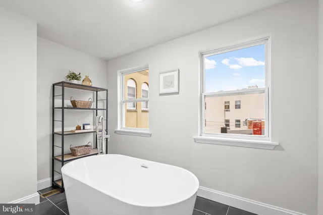 a white bath tub sitting next to a window