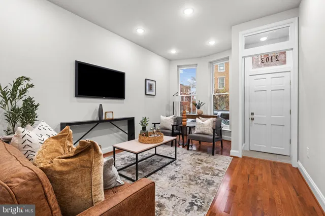 a living room with furniture and a flat screen tv